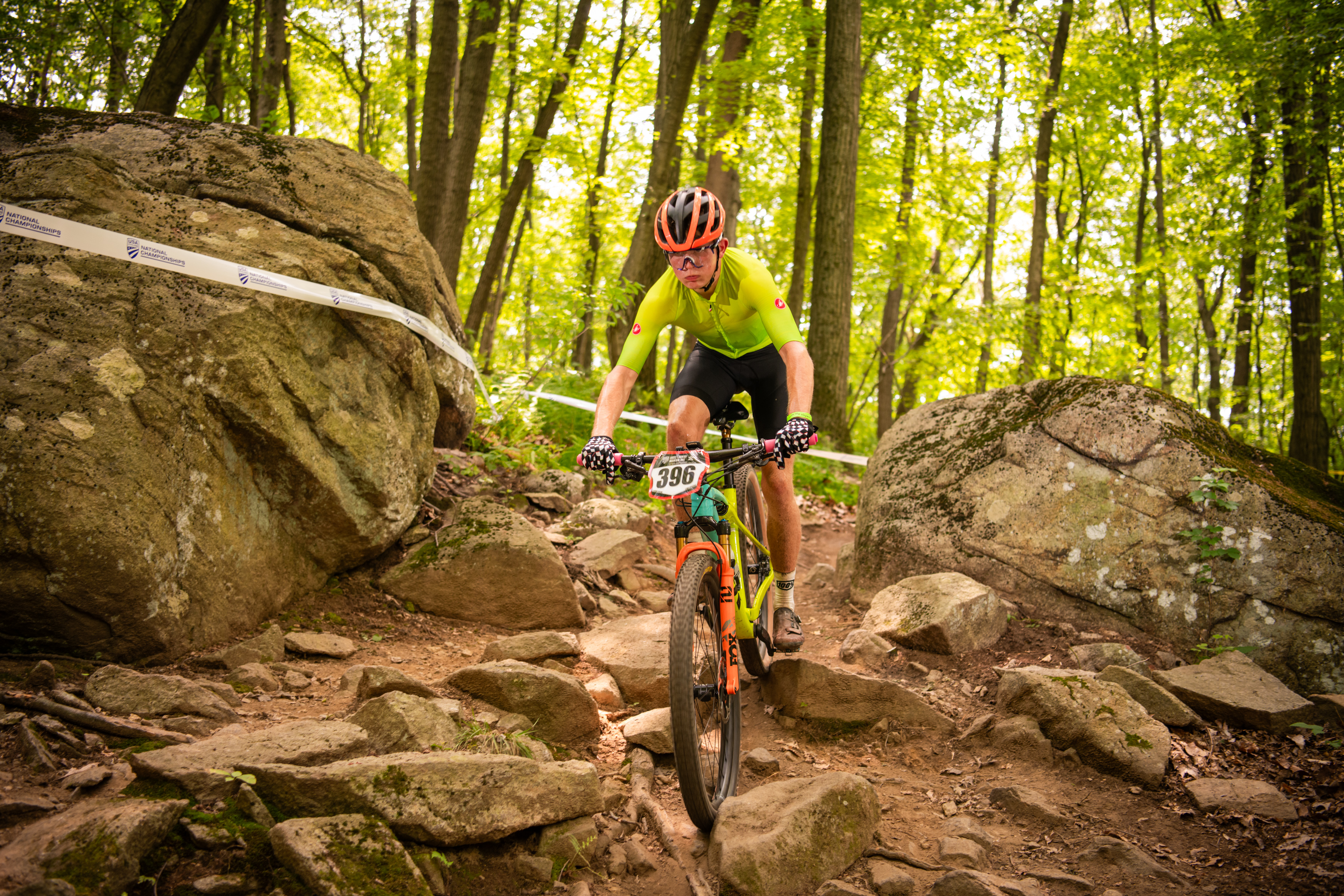 Jack Stapleton racing down a rocky singletrack section